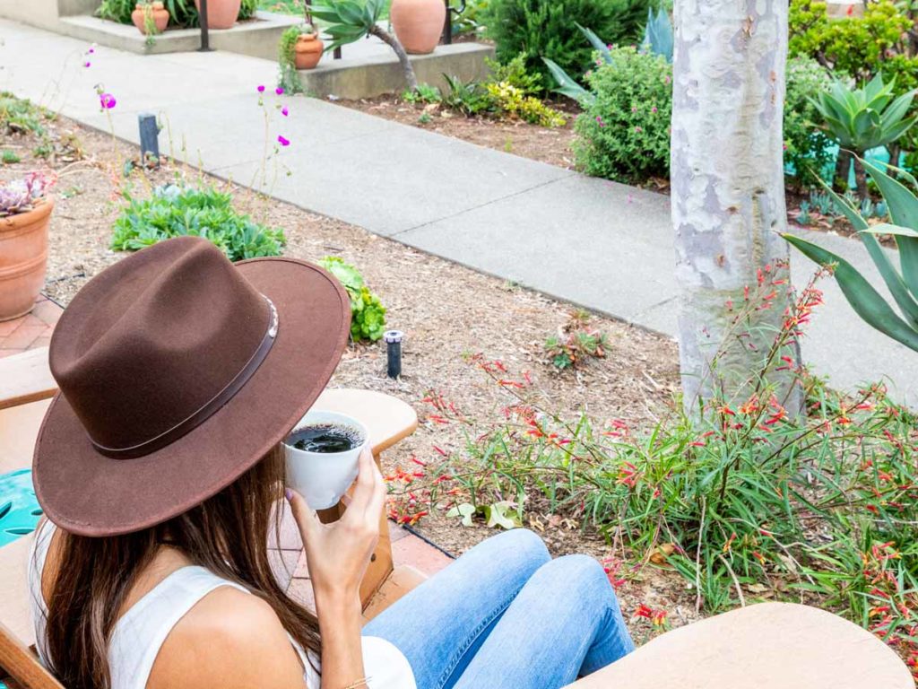 Lady Drinking Coffee In The Garden.