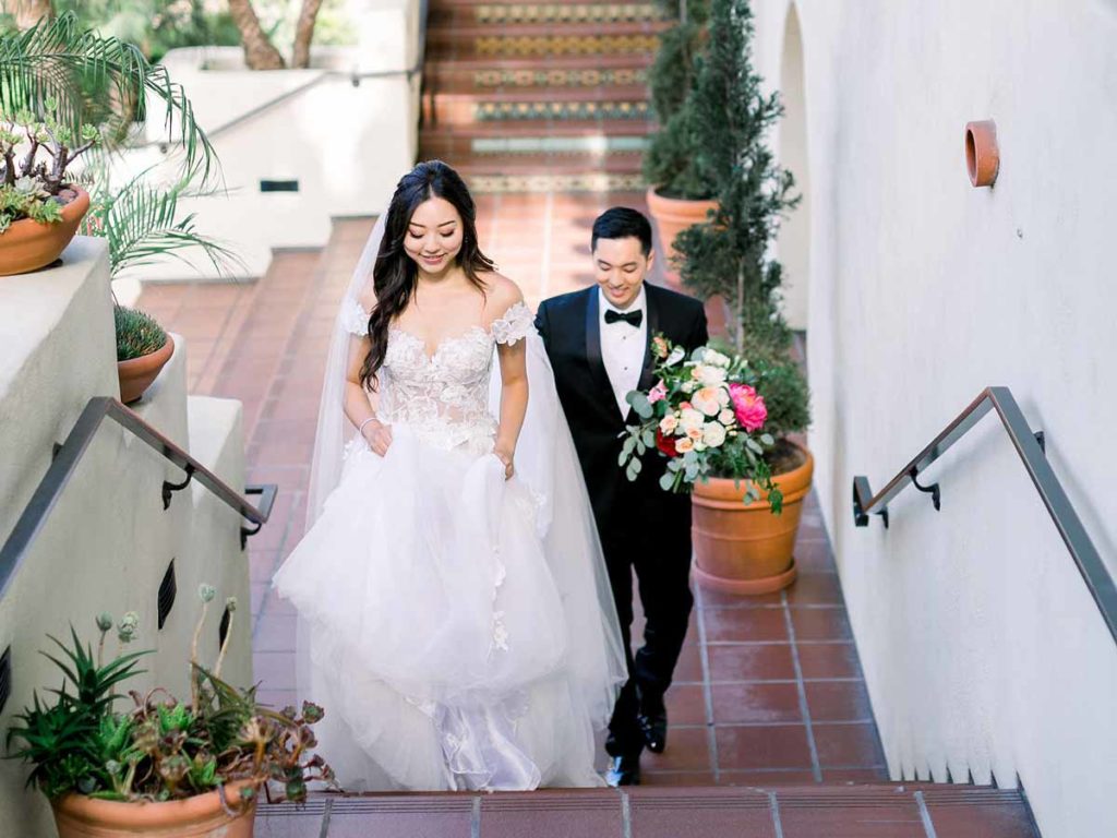 Bride And Groom Walking Up Stairs.