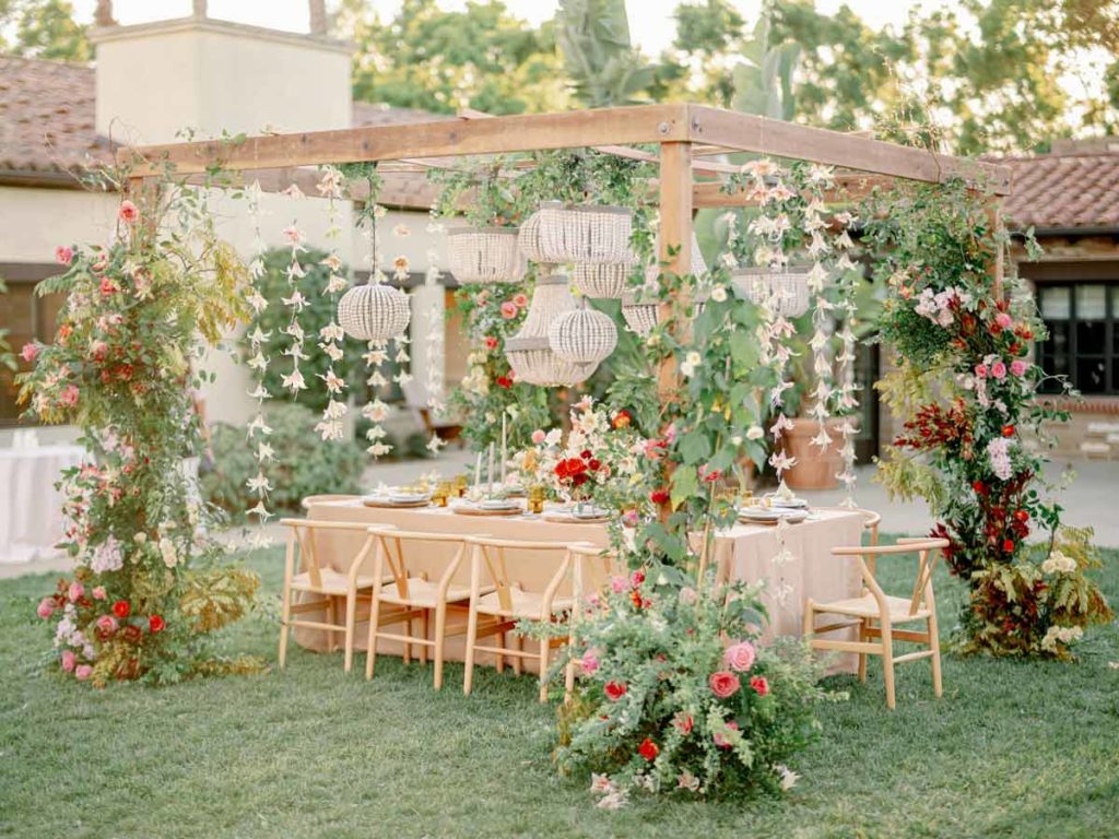 Wedding Reception Table Under Flowery Arbor.