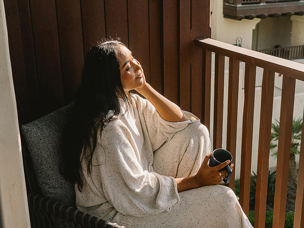 Lady Relaxing On The Balcony.